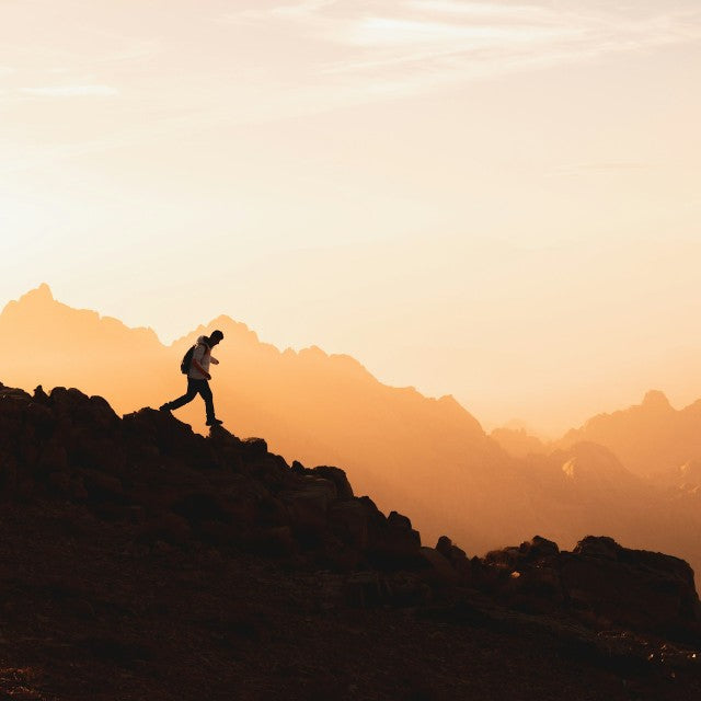 Hiker overlooking a mountain landscape during an outdoor outing